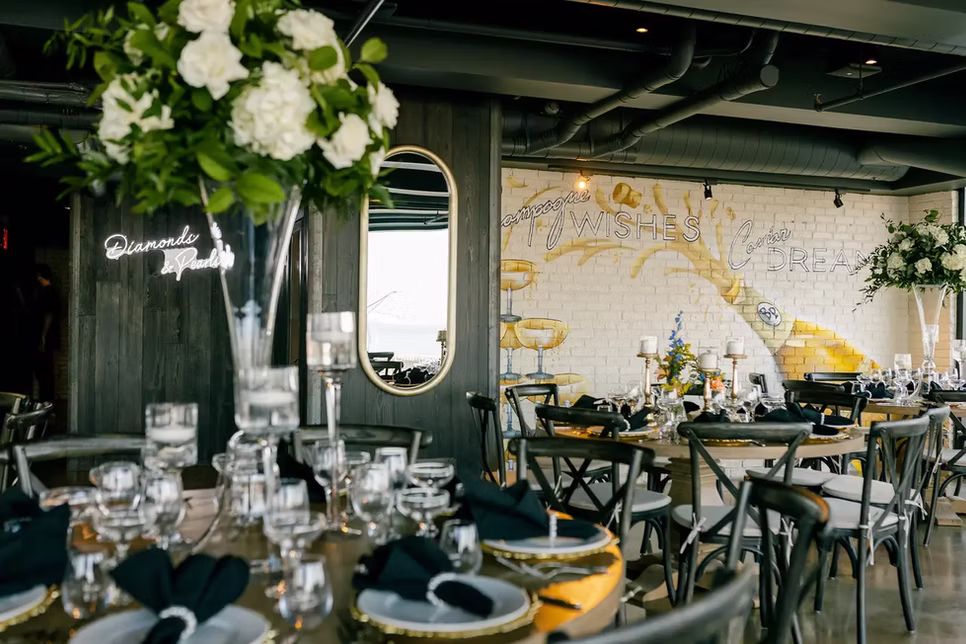 The Loft set for a wedding, Diamonds & Pearls neon beside the Champagne Wishes mural